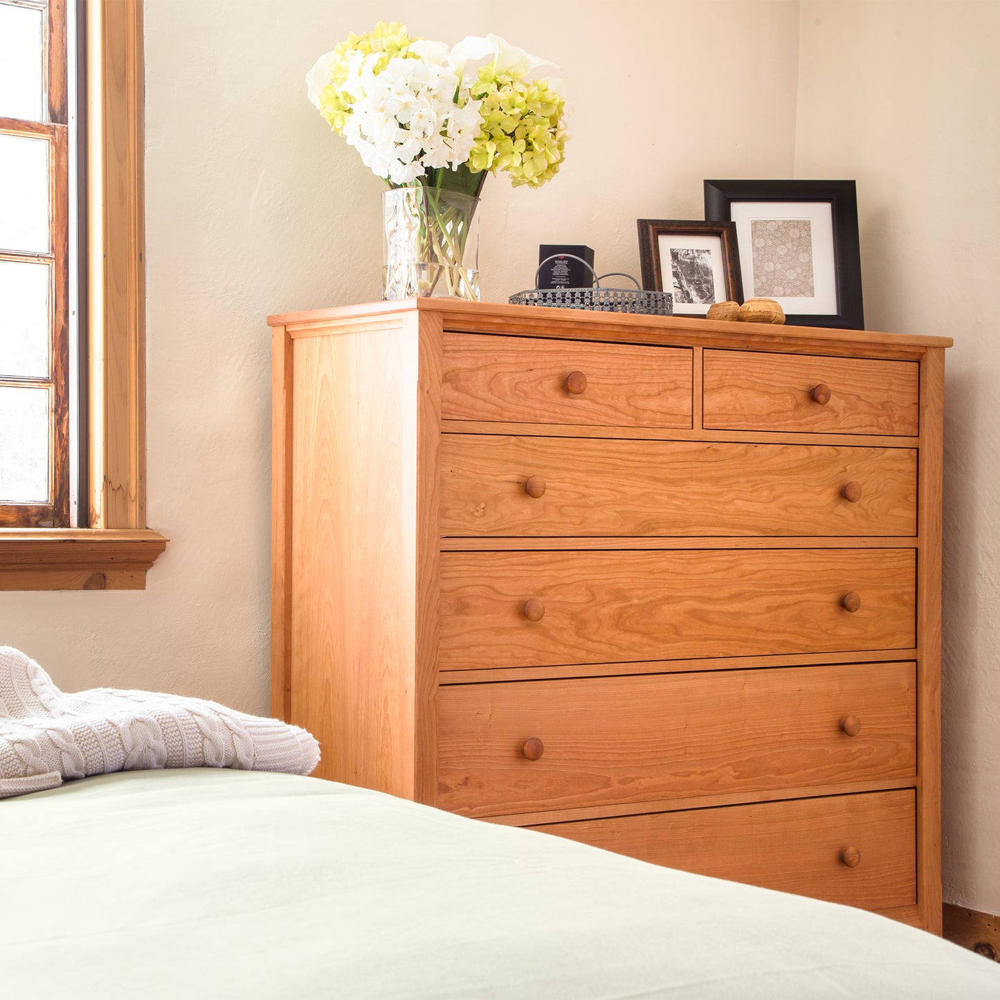 Maple Corner Woodworks Vermont Shaker Extra Wide Chest in solid wood, expertly crafted and positioned as the focal point beside the bed.