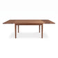 Vermont Shaker Harvest Extension Dining Table by Maple Corner Woodworks with four legs and extension leaves highlighted against a plain background.