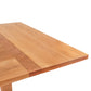 A warm Maple Corner Woodworks Vermont Shaker Harvest Extension Dining Table with a wooden top.