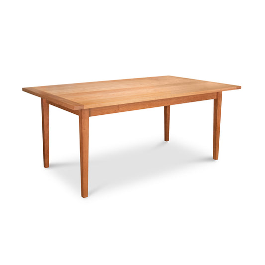 A simple wooden Maple Corner Woodworks Vermont Shaker Solid Top Harvest Table with a rectangular solid top and four straight legs, isolated on a white background.
