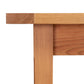 Close-up of a Vermont Shaker Solid Top Harvest Table corner from Maple Corner Woodworks showing the joining technique with visible wood grain and texture, isolated on a white background.