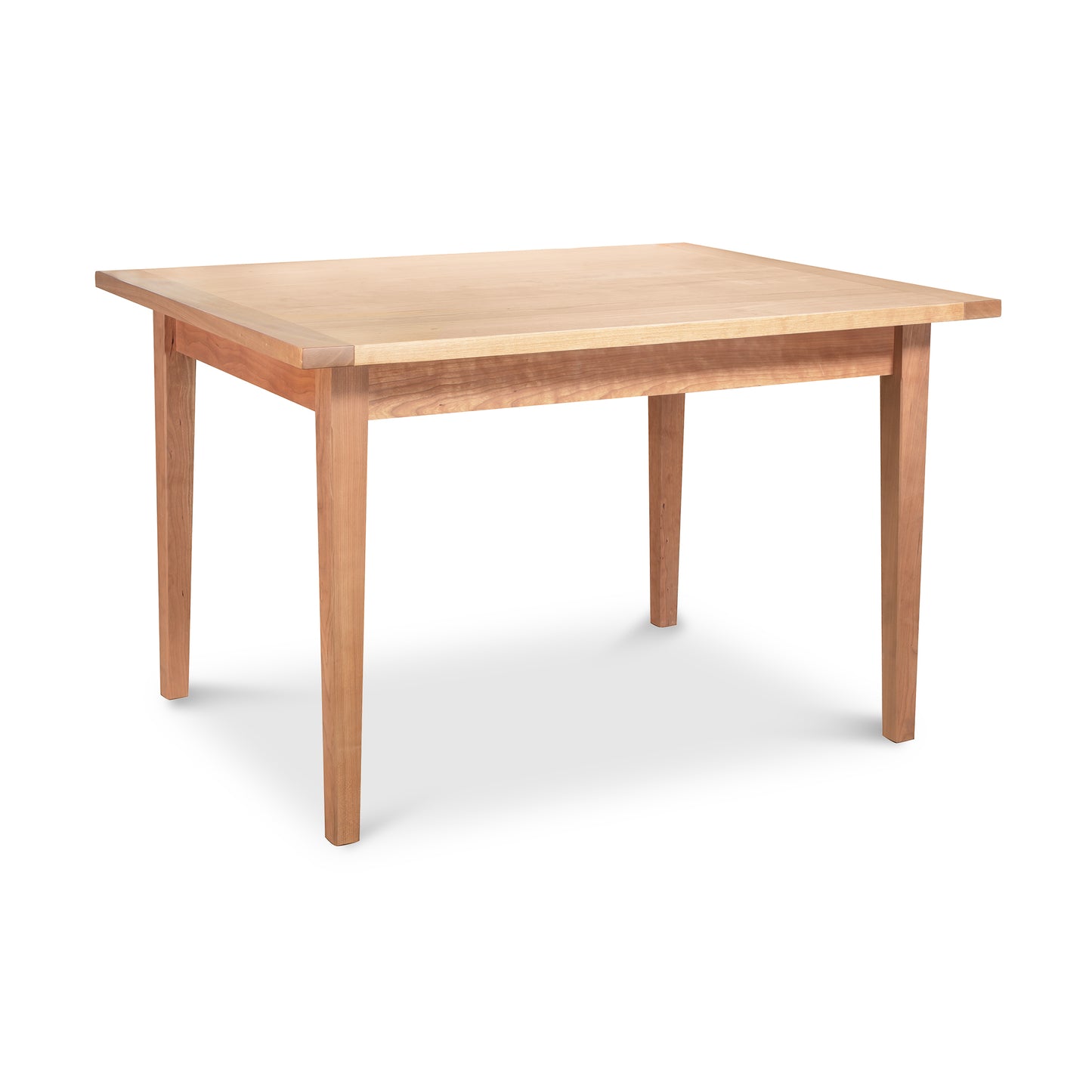 A simple wooden Maple Corner Woodworks Vermont Shaker Solid Top Harvest Dining Table with a light finish and four sturdy legs, isolated on a white background.