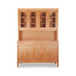 Vermont Shaker Large China Cabinet by Maple Corner Woodworks, crafted from natural cherry hardwood, featuring glass-paneled upper cabinets with lower drawers and cupboard doors.