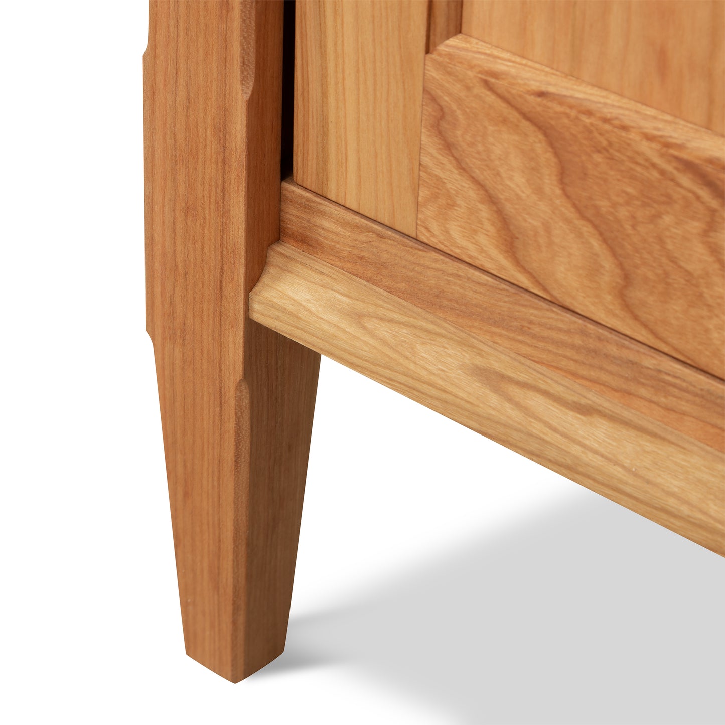 Vermont Shaker Narrow Bookcase leg with natural grain and tapered design by Maple Corner Woodworks.