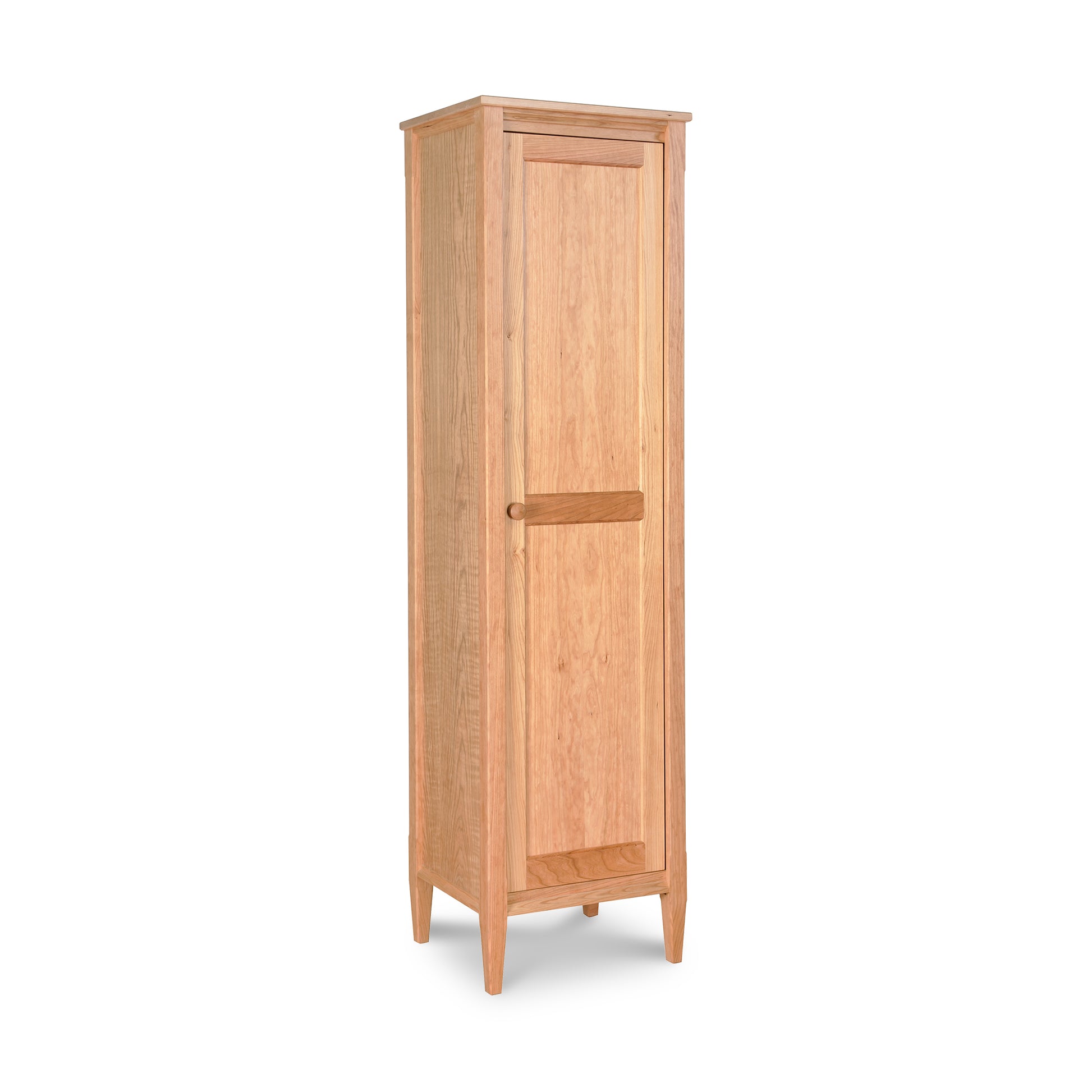 Tall light brown Maple Corner Woodworks Vermont Shaker Bookcase with one door, round handle, and four small legs.