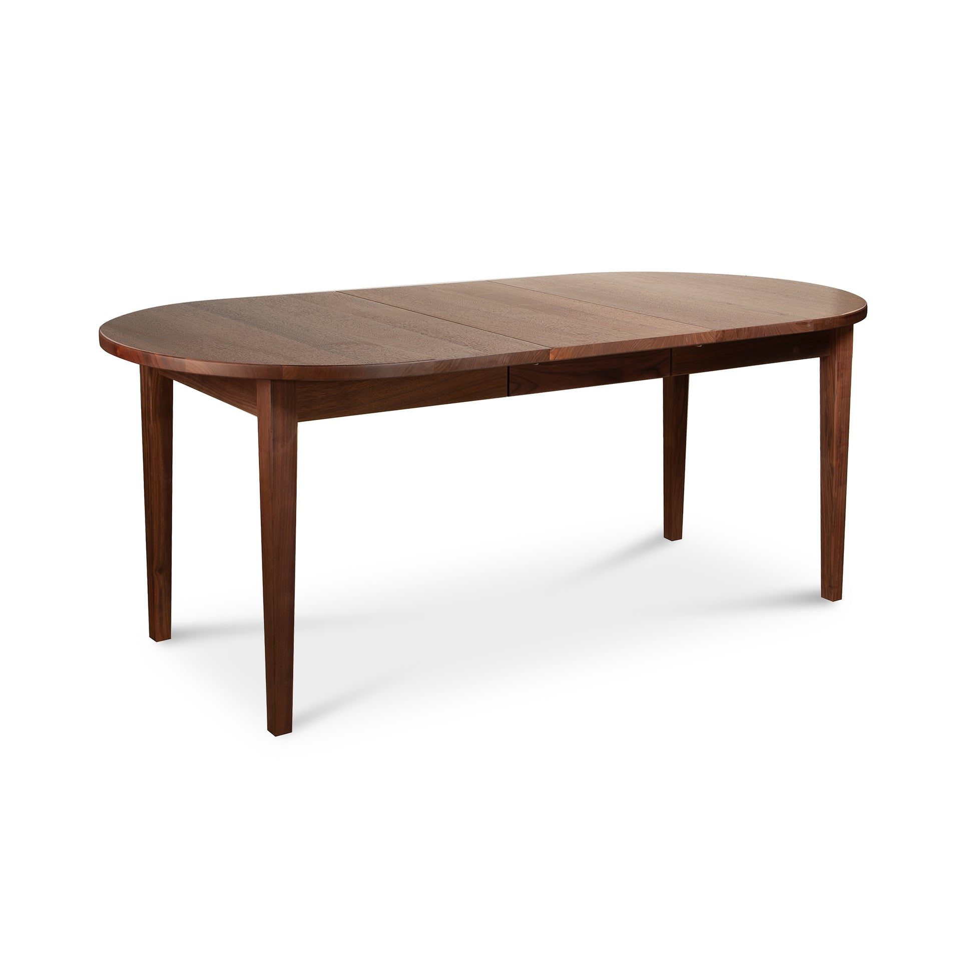 Vermont Shaker Oval Extension Dining Table by Maple Corner Woodworks, showing its smooth hardwood top and four straight legs.