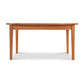 A Vermont Shaker Oval Solid Top Dining Table from Maple Corner Woodworks with a rectangular top and four legs, isolated on a white background. The table displays a smooth finish and a warm brown color.
