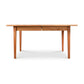 A Vermont Shaker Rectangular Extension Dining Table made from sustainably harvested wood, with four legs, isolated on a white background. Brand: Maple Corner Woodworks.