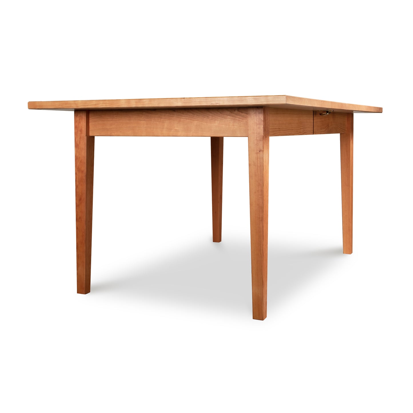 A handcrafted Maple Corner Woodworks Vermont Shaker Rectangular Extension Dining Table made from solid wood, featuring a wooden top and legs.