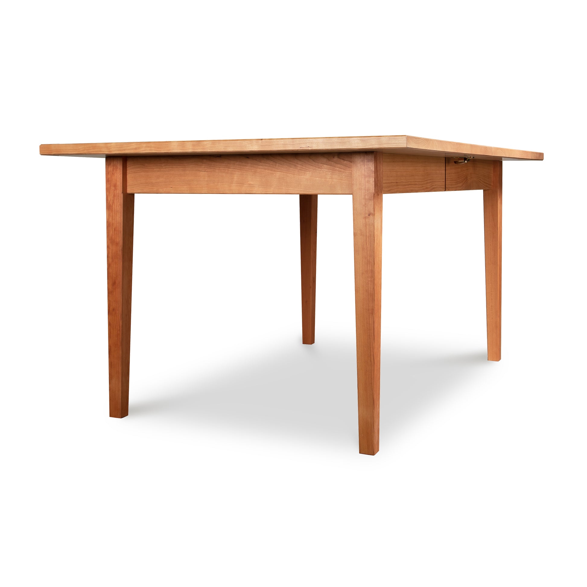 A handcrafted Maple Corner Woodworks Vermont Shaker Rectangular Extension Dining Table made from solid wood, featuring a wooden top and legs.