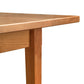 A close up image of a Maple Corner Woodworks Vermont Shaker Rectangular Extension Dining Table.