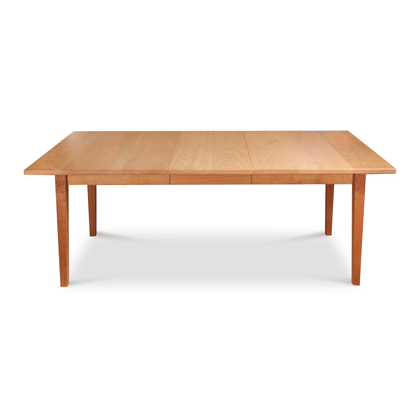 A Vermont Shaker Rectangular Extension Dining Table made from sustainably harvested wood, with extendable leaves on each end, standing on four legs, isolated against a white background. - Maple Corner Woodworks