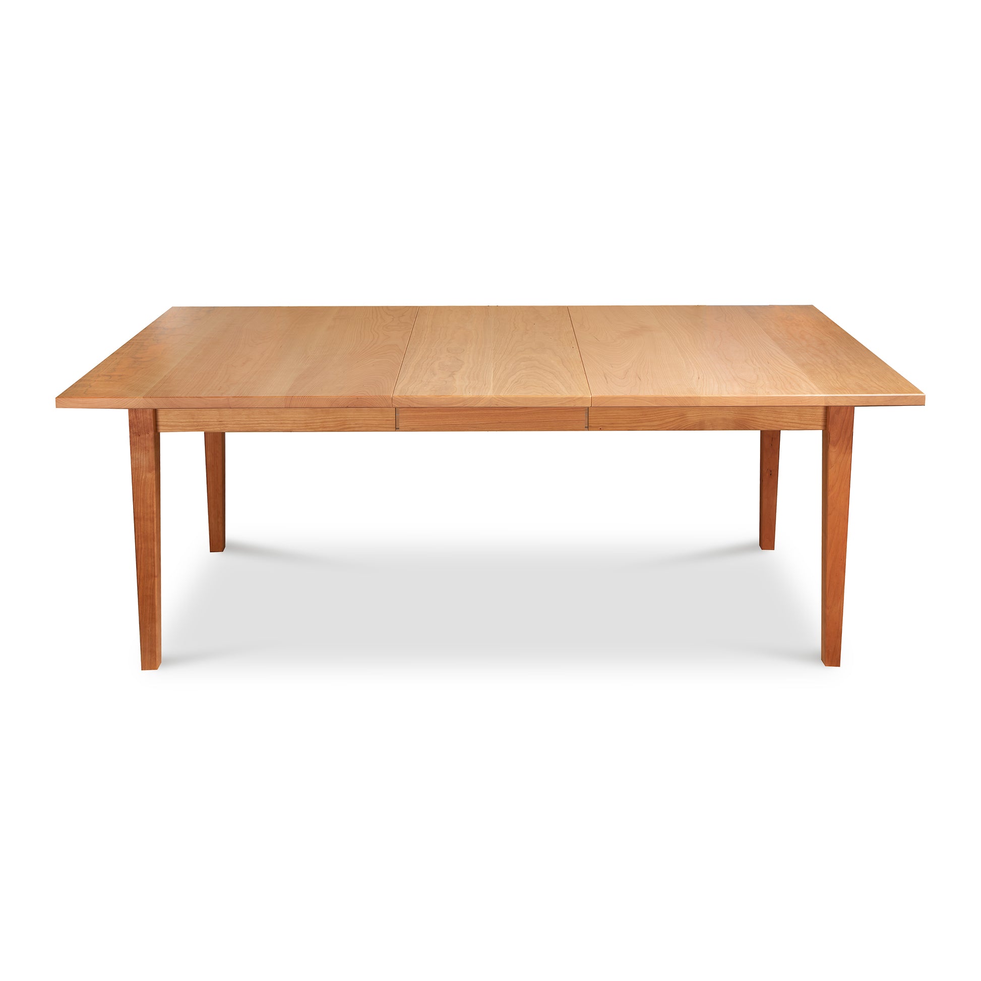 A Maple Corner Woodworks Vermont Shaker Rectangular Extension Dining Table with extendable leaves, isolated on a white background.
