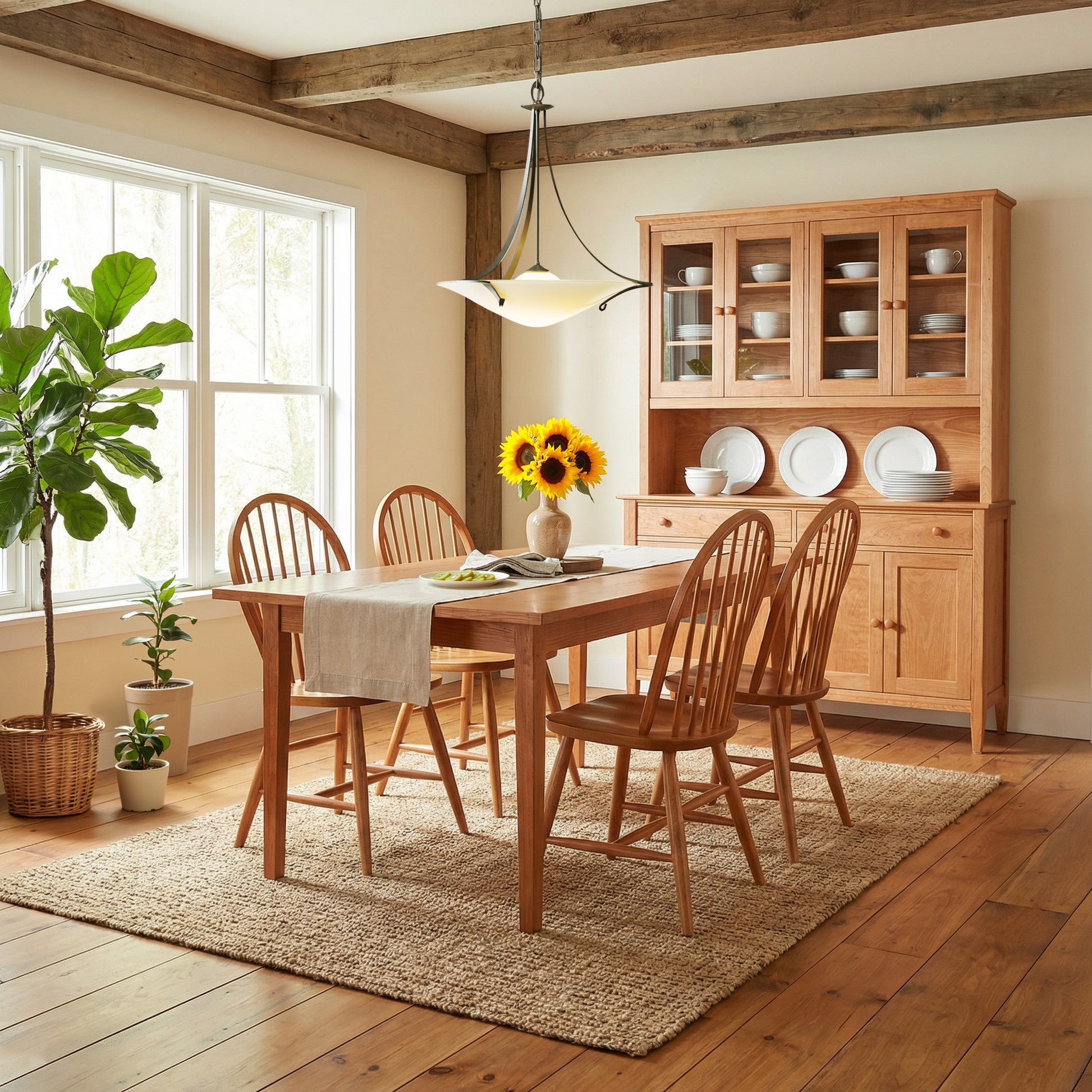 Lyndon Furniture Contemporary Windsor Chairs and a solid wood dining table, handcrafted in Vermont, set for dining; sunflower centerpiece adds a touch of color.