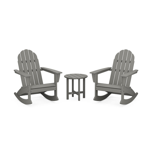 Two gray POLYWOOD Vineyard 3-Piece Adirondack Rocking Chair Sets facing each other with a small round table in between, set against a white background. The chairs feature a classic slatted design with curved backrest.