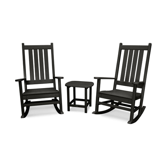 Two black traditional wooden rocking chairs and a small matching side table arranged on a white background. The chairs, part of the POLYWOOD® Vineyard 3-Piece Rocking Set series, feature vertical slats.