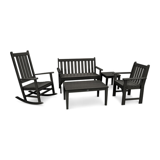A set of black POLYWOOD® Vineyard 5-Piece Bench & Rocking Chair Set consisting of a rocking chair, a bench, two armchairs, and a small rectangular coffee table, arranged on a white background.