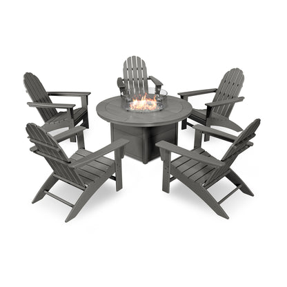 A set of five dark gray POLYWOOD Vineyard Adirondack 6-Piece Chat Set with Fire Pit Table chairs arranged around a circular fire pit table with visible flames, isolated on a white background.