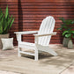 A white POLYWOOD Vineyard Adirondack Chair, meticulously crafted from sturdy POLYWOOD® lumber, is elegantly placed on a beige rug surrounded by vibrant potted plants and complemented by a striped cushion. The outdoor furniture piece is bordered by a wooden fence with horizontal slats, creating a tranquil atmosphere in the patio setting.