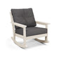 A modern POLYWOOD® Vineyard Deep Seating Rocking Chair with a light beige frame and dark grey cushions on a white background.