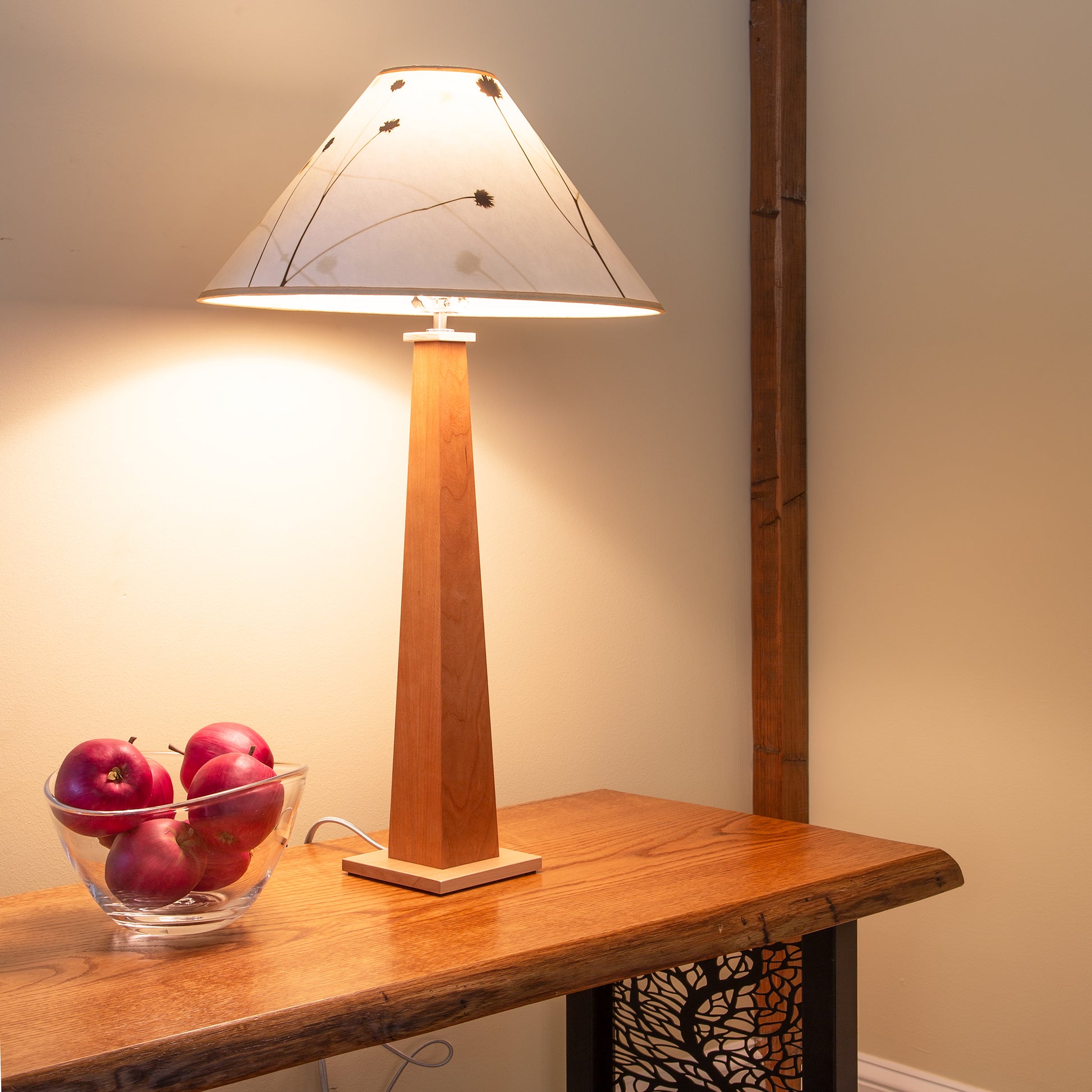 Rock River Studio Winter Hill Table Lamp with a white shade featuring modern design, showcased on a wooden table.
