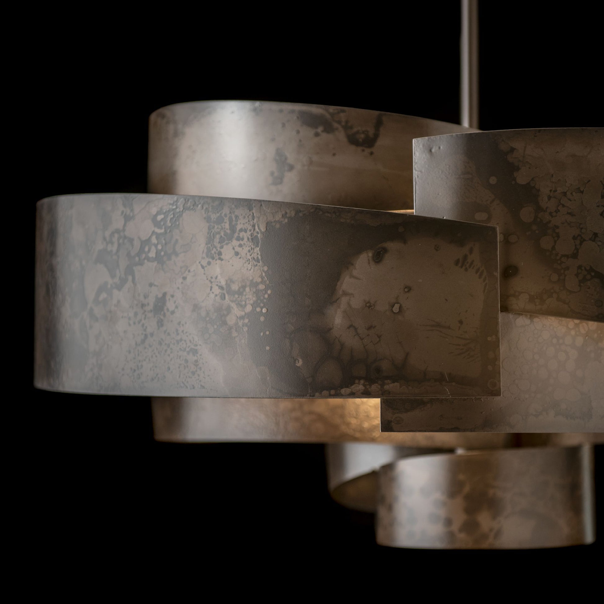 Zen Pendant by Hubbardton Forge featuring wide overlapping bands and a handcrafted marbled finish, highlighting its unique design and artisan craftsmanship.