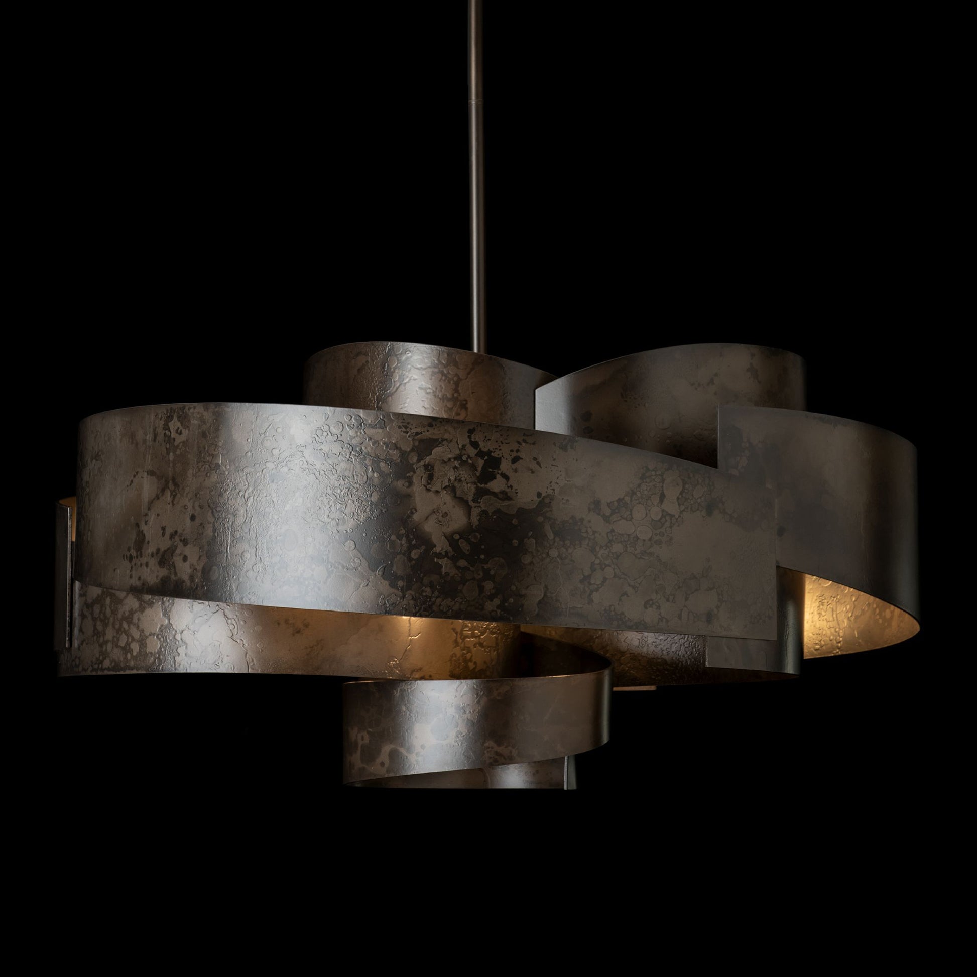 Zen Pendant light by Hubbardton Forge with wide, handcrafted metallic bands forming a modern spiral design.