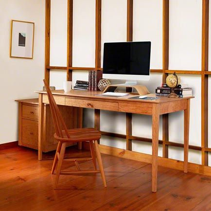 A wooden desk in a room.