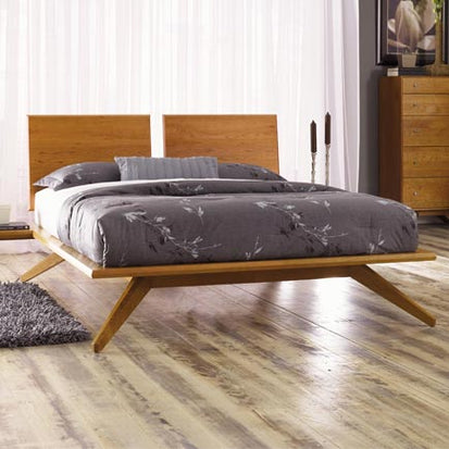 A modern bedroom with wooden floors and a wooden bed.