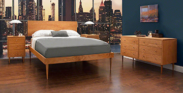 A bedroom with a mural on the wall.