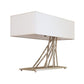 Brindille Table Lamp by Hubbardton Forge with sculpted branch-like metal rods and a white shade, showcasing elegant, artisan-crafted lighting design.