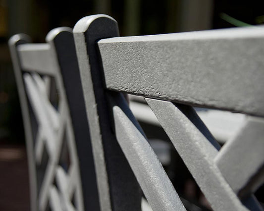 A close up of a Polywood gray patio chair.