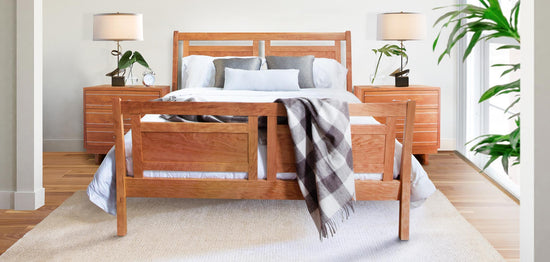 A bedroom with a wooden bed and dresser.