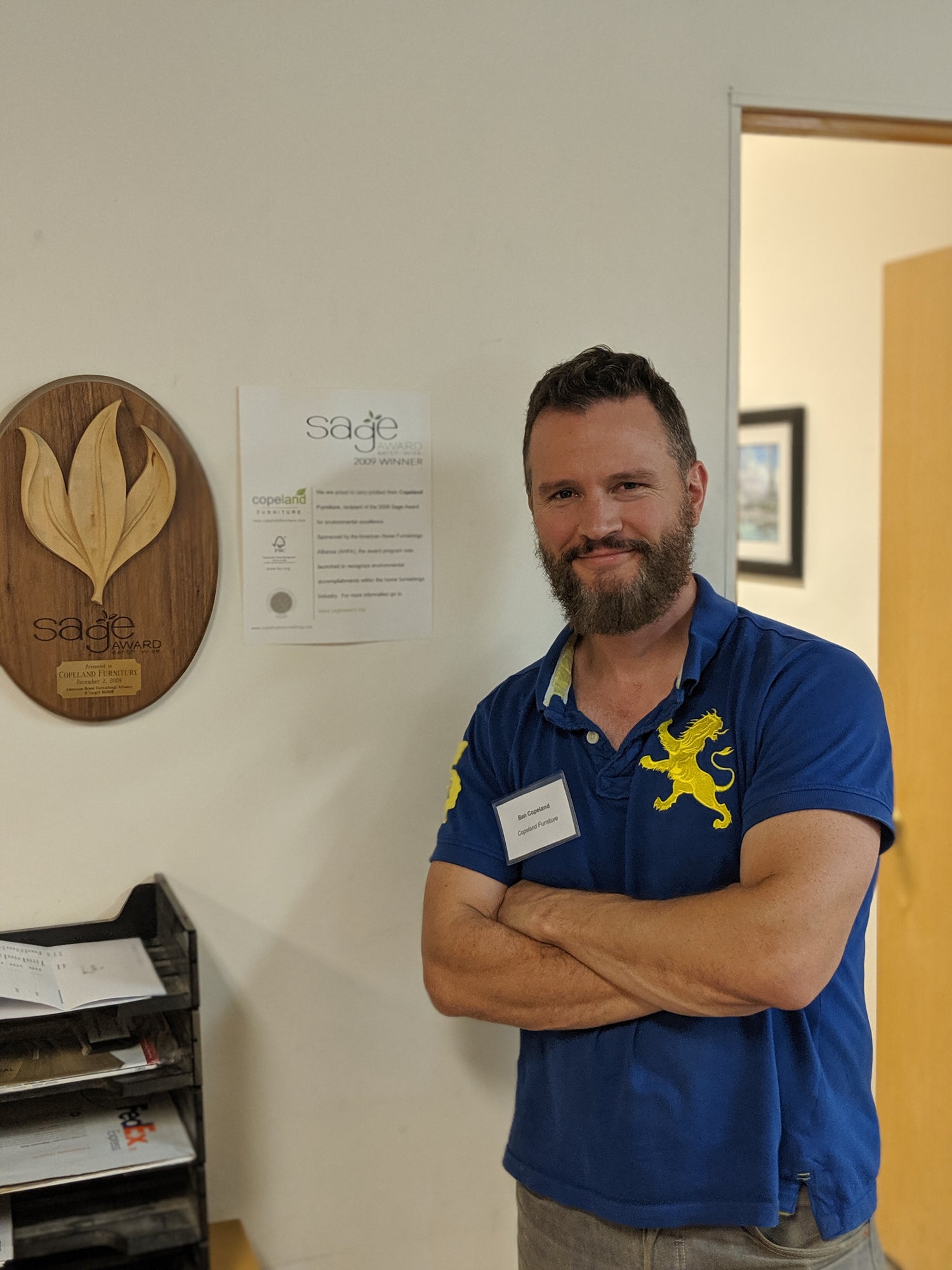 Ben Copeland stands proudly next to Sage Award for Innovation in Sustainable Practices