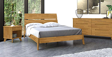 Wooden bed, nightstand, and dresser set on a gray floor.