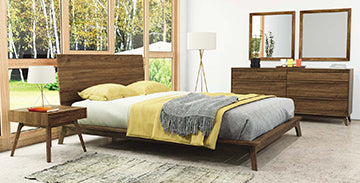 A bedroom with a bed, dresser and mirror.