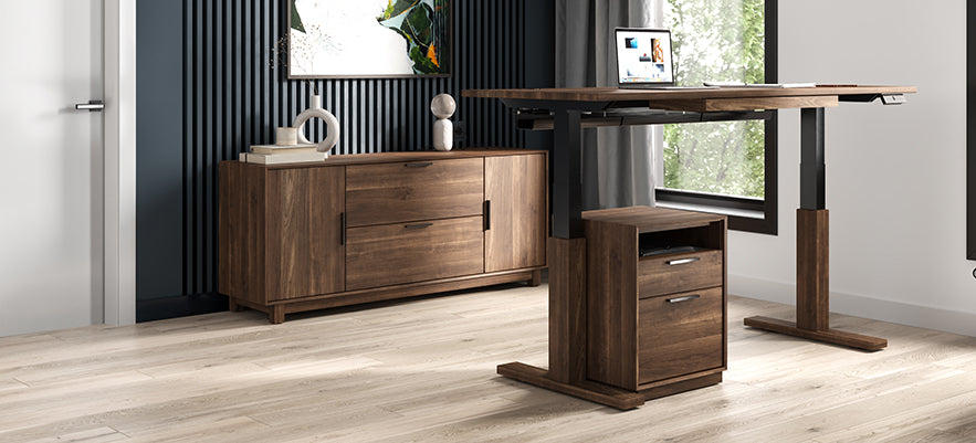 Wooden standing desk accompanied by a matching cabinet, featuring a laptop and decorative items.