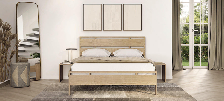 Wooden bed with two pillows and a bedside lamp, featuring a modern design.