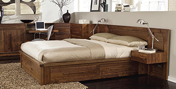 Wooden bed with built-in drawers and beige bedding.