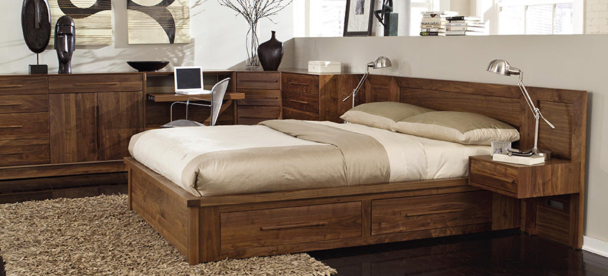 Wooden bed with built-in drawers and beige bedding.