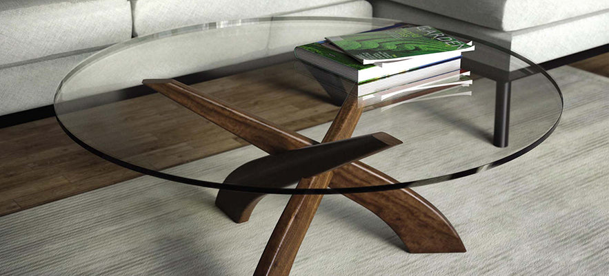 A coffee table with a glass top and a wooden base.