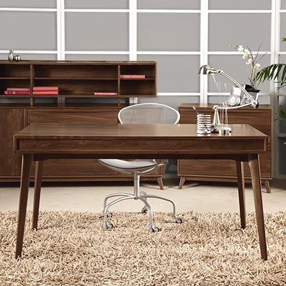 A modern home office with a desk, chair and bookshelf.