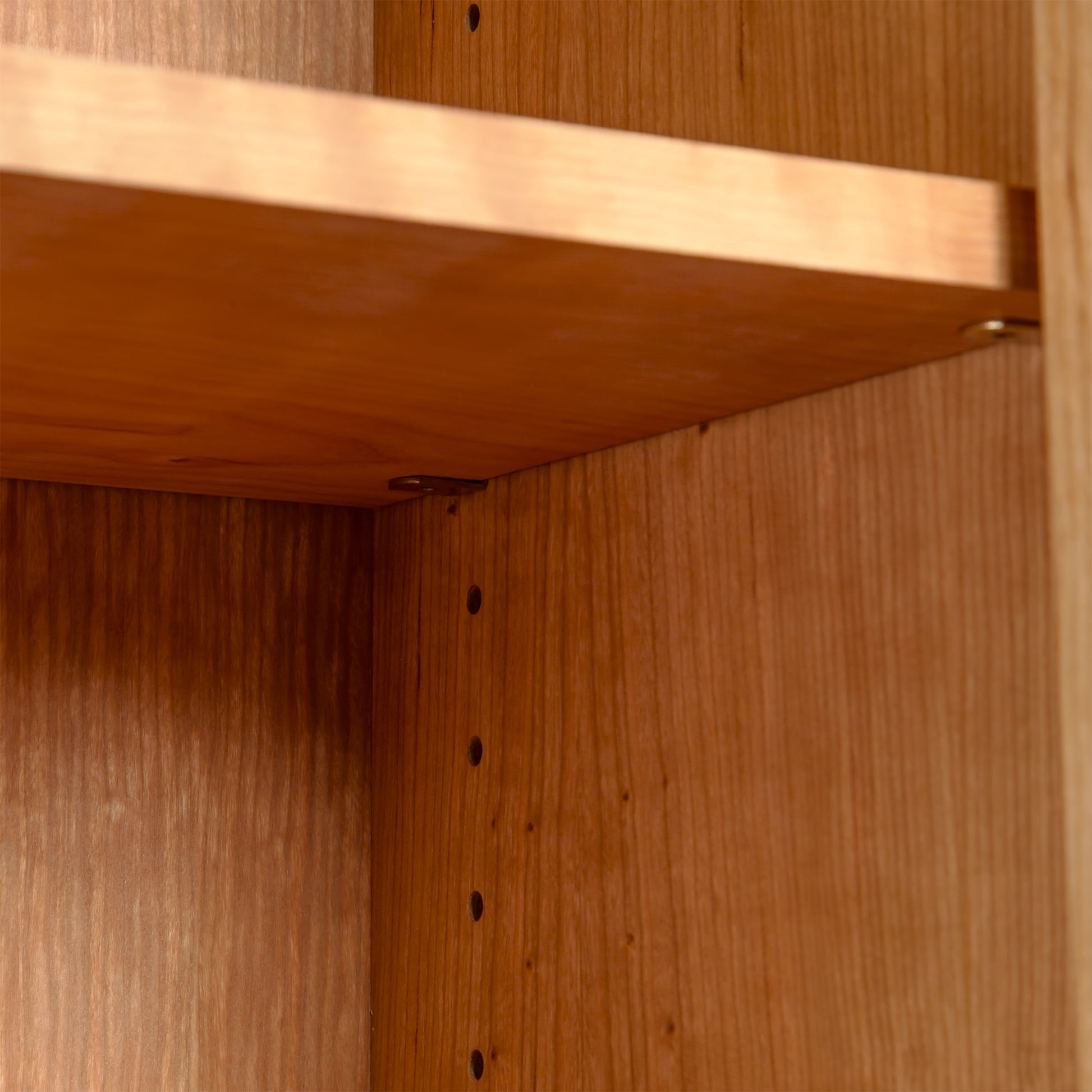 Maple Corner Woodworks Custom Vermont Shaker Bookcase with Glass Doors, featuring adjustable shelves and support holes in the solid hardwood frame.