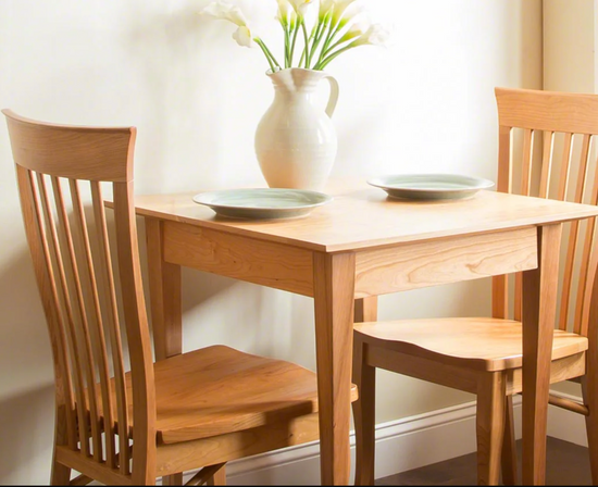 A small dining table with two chairs.