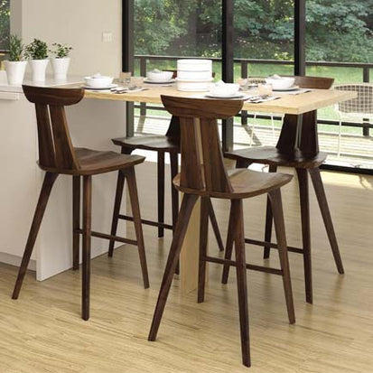 A modern kitchen with a wooden table and chairs.