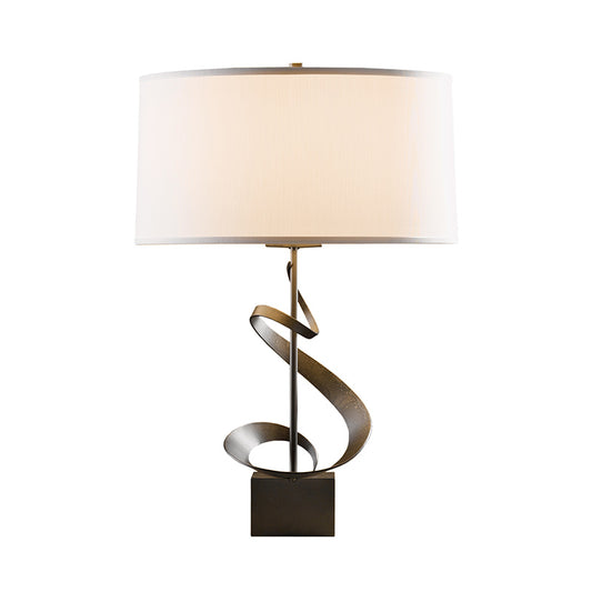 Hubbardton Forge Gallery Spiral Table Lamp with twisted bronze base and white cylinder shade, American made artisan lighting.