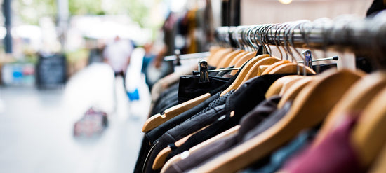 High-quality wooden clothing rack showcasing neatly arranged hangers.