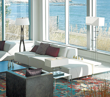 White sofa with geometric cushions in a modern living room setting.