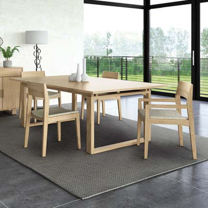 A modern dining room with a wooden table and chairs.
