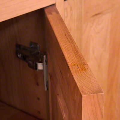 A close up of a wooden cabinet door.